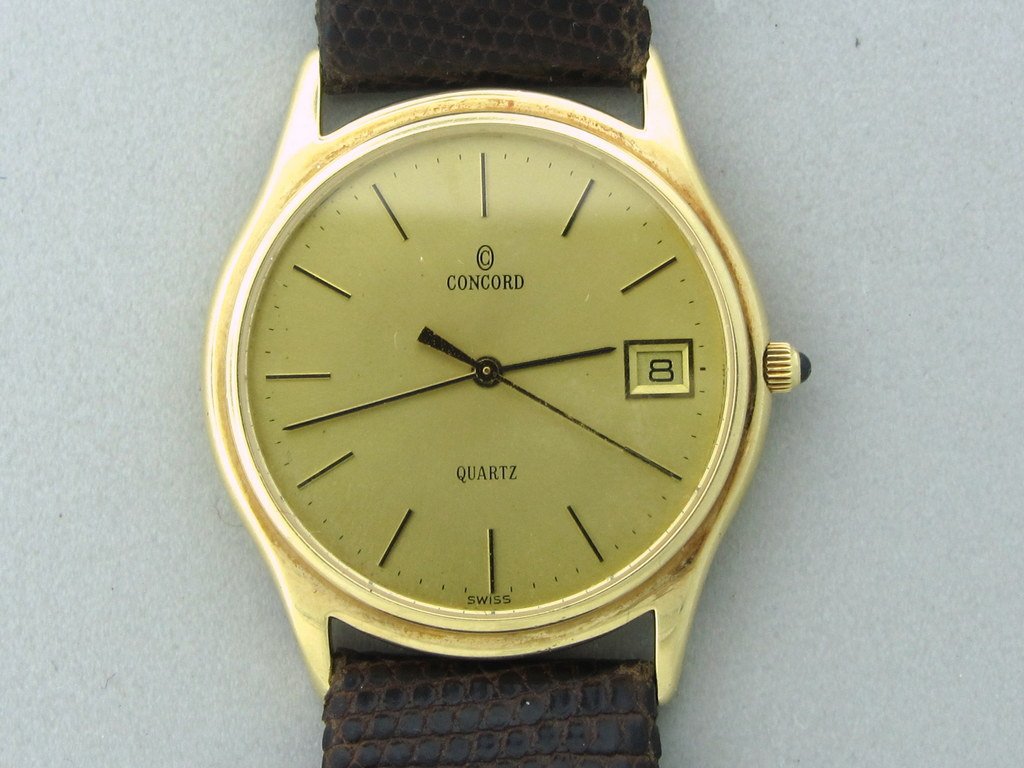 Modern Concord 14k Gold Men's Watch: Solid 14k yellow gold screw down case 40mm (lug tip to lug tip )X 34mm ( excluding crown ). date window at 3 o'clock . Center second hand.