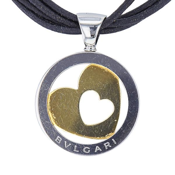 Bvlgari Bulgari Tondo 18k Yellow Gold and Stainless Steel Heart Cord Pendant Necklace: METAL: 18k Yellow Gold, Stainless Steel. MEASUREMENTS: Length 15 inches, center pendant 42mm x 32mm with bail. MARKED: Bvlgari, Made in Italy, maker's mark, assay mark, Gold and Steel. WEIGHT: 23.