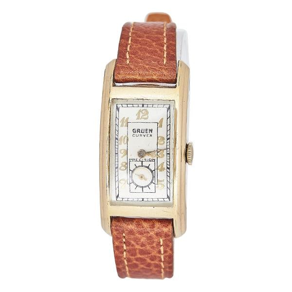 Gruen 14k Yellow Gold Filled Watch Ref. 012697, circa 1960: CASE MATERIAL: 14k Yellow Gold Filled. STRAP: Genuine Leather. CASE SIZE (mm): 25 x 41. BEZEL: 14k Yellow Gold. MOVEMENT TYPE: Manual. DIAL COLOR: Silver. CRYSTAL: Acrylic. CRYSTAL CONDITION: Good. CA