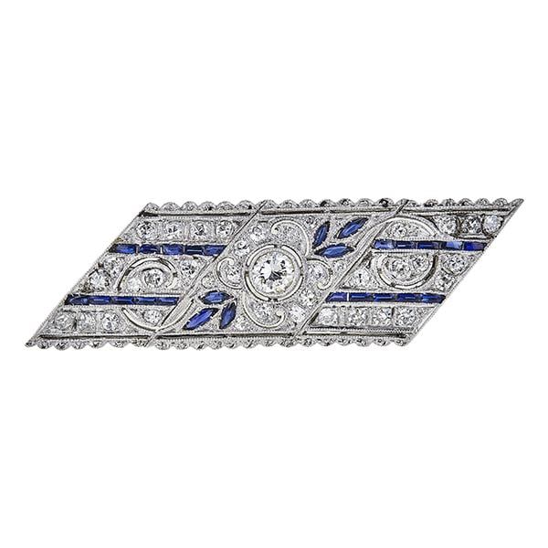 14k White Gold Round and Single-Cut Diamond and Sapphire Rhomboid Brooch Pin: Round and single cut diamonds weighing approx. 0.80 ctw. Brooch measuring approx. 45mm x 13mm. 4.3 grams. Gemstones have not been graded for color and clarity, and tested for clarity and color enhance