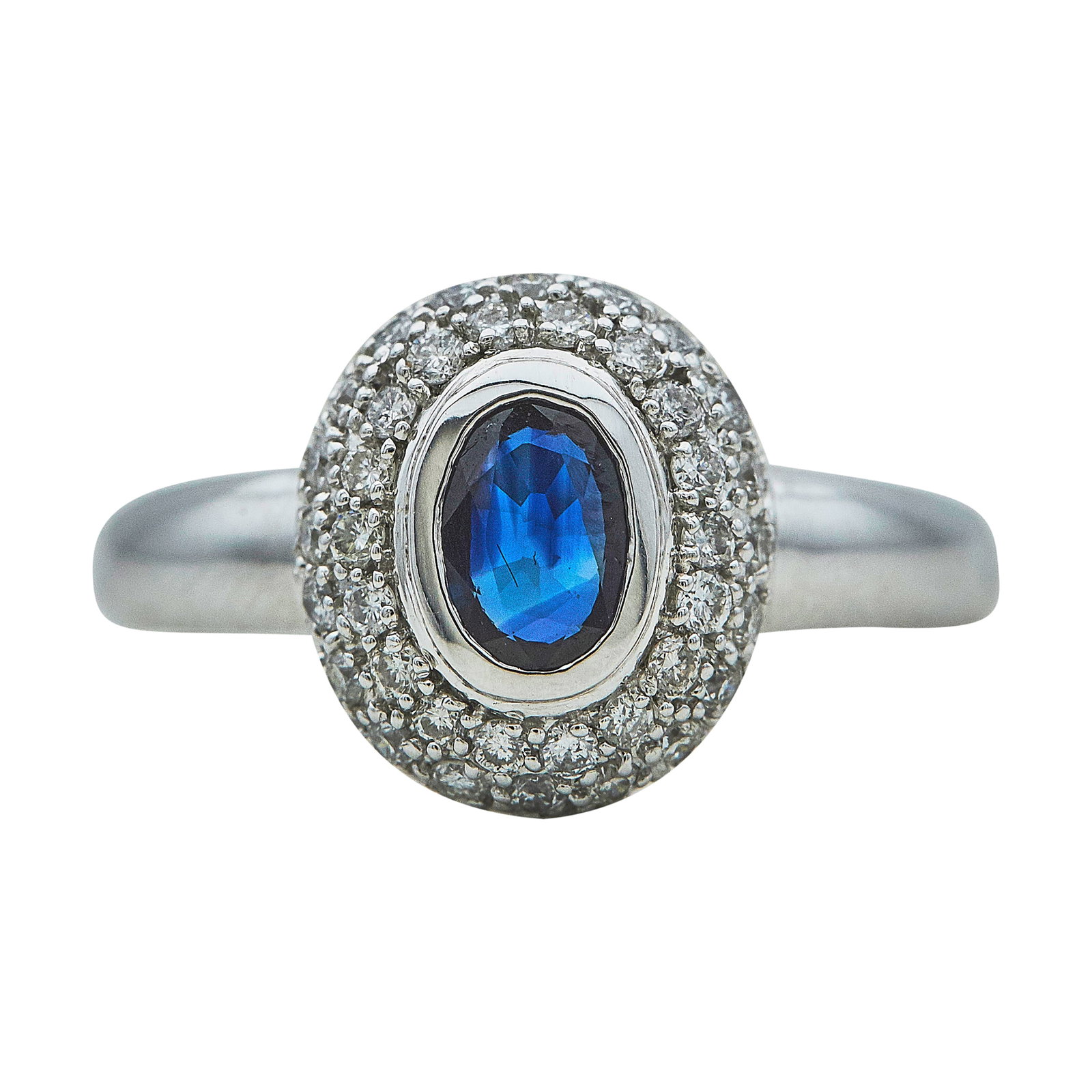 14K White Gold Oval-Cut Sapphire and Pavé Diamond Ring: METAL: 14K White Gold; APPROXIMATE TOTAL DIAMOND WEIGHT: 1 ctw; GEMSTONES: Sapphire weighing approx. 0.50 carat; STAMPED: 14K, WCO; CONDITION: Pre-owned, Very Good; ITEM WEIGHT (GRAMS): 4.7 g; MEASURE
