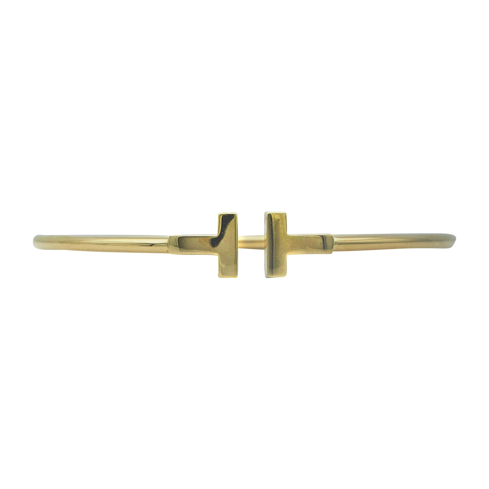 Tiffany & Co. Tiffany T 18K Yellow Gold Wire Bangle Bracelet: BRAND: Tiffany & Co.; METAL: 18K Yellow Gold; STAMPED: T&CO, Au750, ITALY, numbered, maker's marks, assay marks,; CONDITION: Pre-owned, Good; ITEM WEIGHT (GRAMS): 8.4 g; MEASUREMENTS: Bracelet fits ap