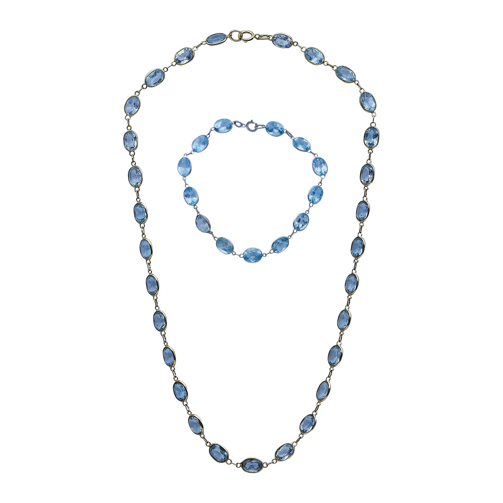 18K Yellow Gold and Blue Topaz Choker Necklace and 18K White Gold and Blue Topaz Bracelet Set: METAL: 18K Yellow Gold/White Gold; GEMSTONES: Blue Topaz; STAMPED: Bracelet clasp marked: 750; Necklace clasp marked: 750; CONDITION: Pre-owned, Fair; ITEM WEIGHT (GRAMS): 11.91 g; MEASUREMENTS: Neckl