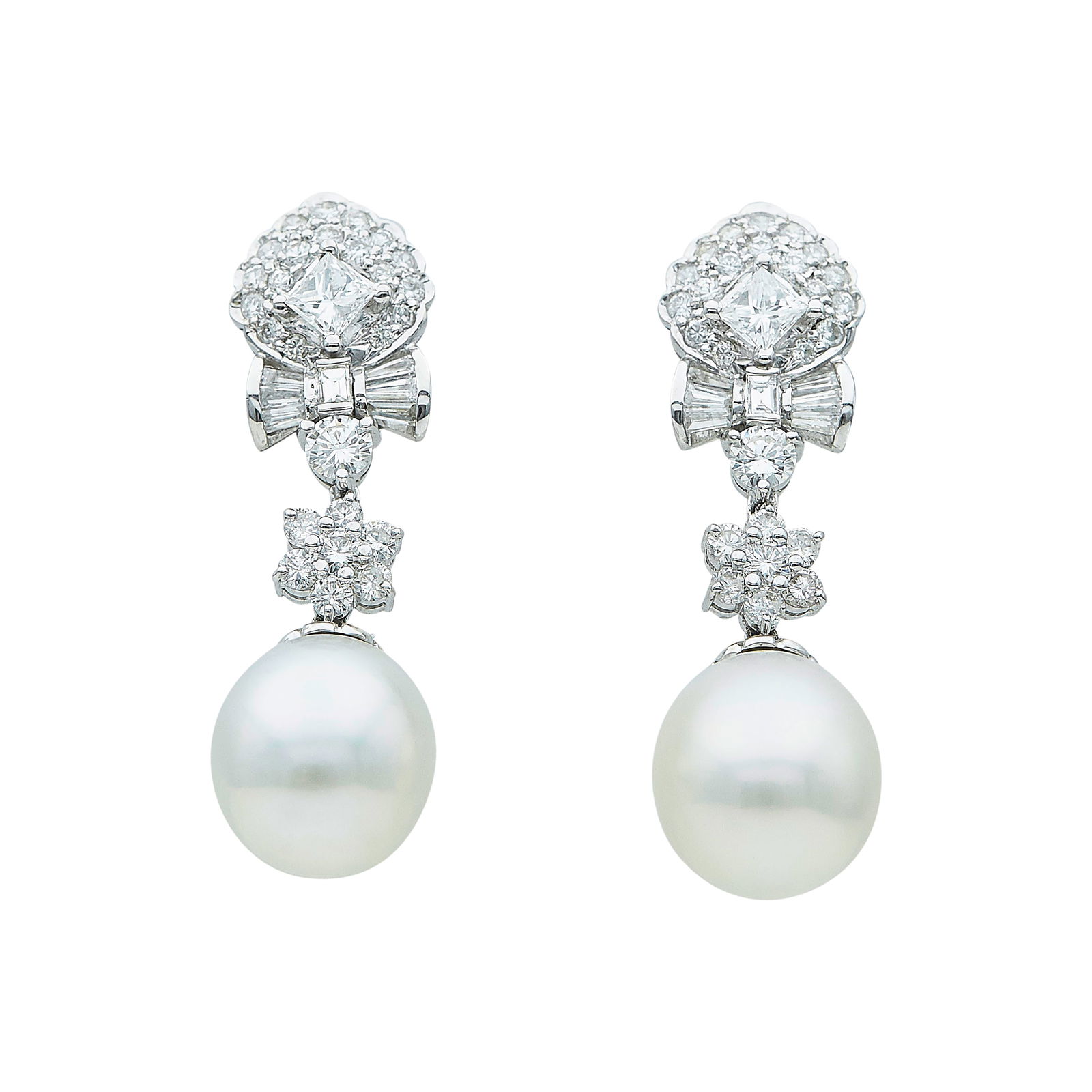 18K White Gold Pearl And Mixed-Cut Diamond Approx. 3.40 CTTW Drop Earrings: METAL: 18K White Gold; APPROXIMATE TOTAL DIAMOND WEIGHT: 3.40 ctw; GEMSTONES: 2 white oval shaped Akoya cultured Pearls measuring approx. 13.25mm by 15.75mm; STAMPED: clutches stamped: D340, 750, 18K,