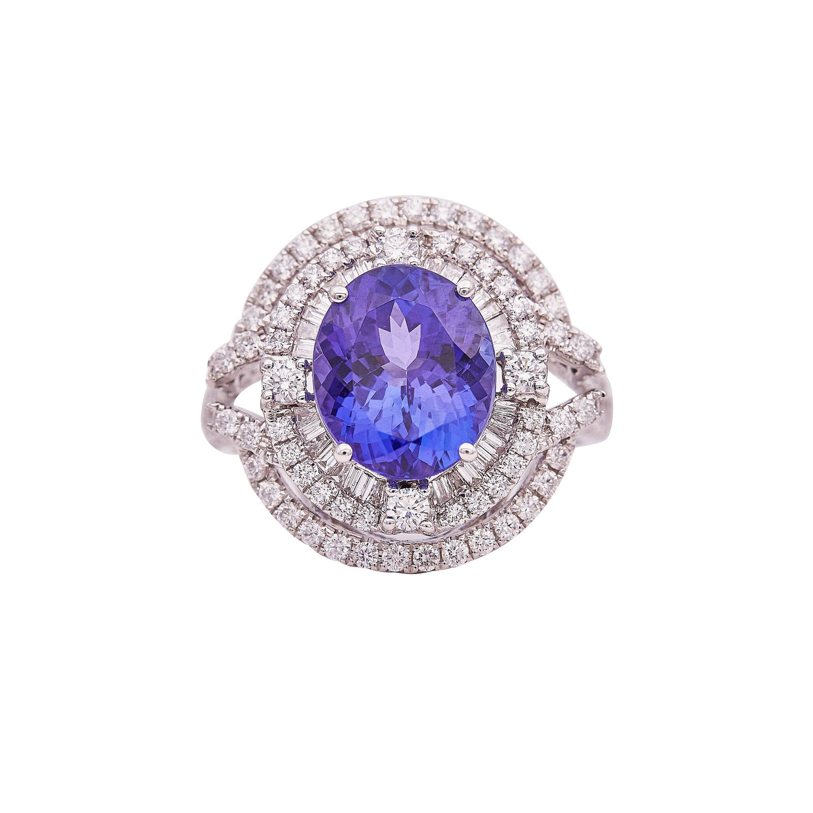 14K White Gold Tanzanite And Diamond Halo Ring: METAL: 14K White Gold; APPROXIMATE TOTAL DIAMOND WEIGHT: 1.40 ctw; GEMSTONES: Tanzanite weighing approx. 5.00 carats, small chip on table; STAMPED: 14KT maker's mark; CONDITION: Pre-owned, Good; ITEM