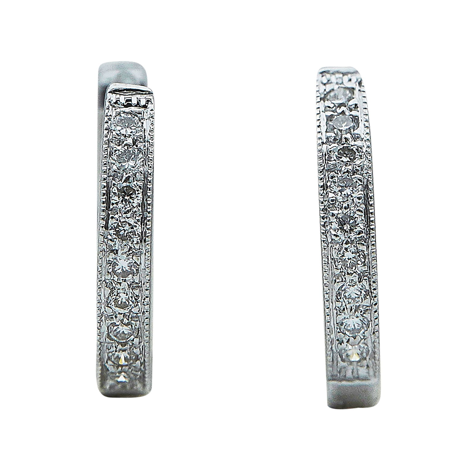 14K White Gold and Diamond Huggie Earrings: METAL: 14K White Gold; APPROXIMATE TOTAL DIAMOND WEIGHT: 0.06 ctw; STAMPED: 14K, CT; CONDITION: Pre-owned, Very Good; ITEM WEIGHT (GRAMS): 1.8 g; MEASUREMENTS: Earrings 1/2 inch in diameter; ADDITIONA