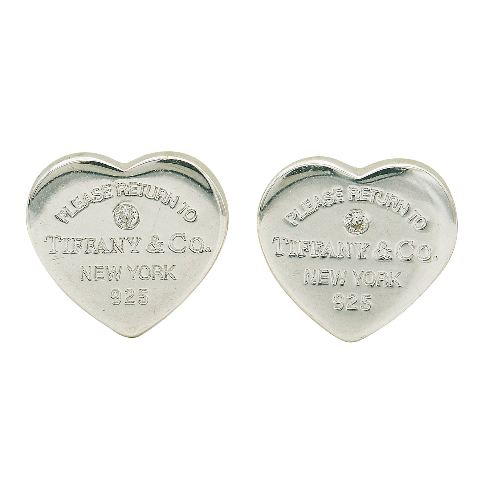 Tiffany & Co. Sterling Silver and Diamond Heart Stud Earrings: BRAND: Tiffany & Co.; METAL: Silver; APPROXIMATE TOTAL DIAMOND WEIGHT: 0.02 ctw; STAMPED: Please Return To TIFFANY & CO. New York, 925; CONDITION: Pre-owned, Very Good; ITEM WEIGHT (GRAMS): 2.3 g; MEA