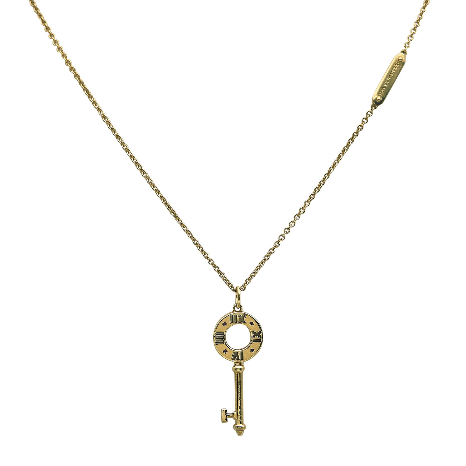 Tiffany & Co. Atlas 18K Yellow Gold and Ruby Key Pendant Necklace: BRAND: Tiffany & Co.; COLLECTION: Atlas; METAL: 18K Yellow Gold; GEMSTONES: Ruby; STAMPED: © Tiffany & Co., Au750; CONDITION: Pre-owned, Very Good; ITEM WEIGHT (GRAMS): 8.49 g; MEASUREMENTS: Chain 20