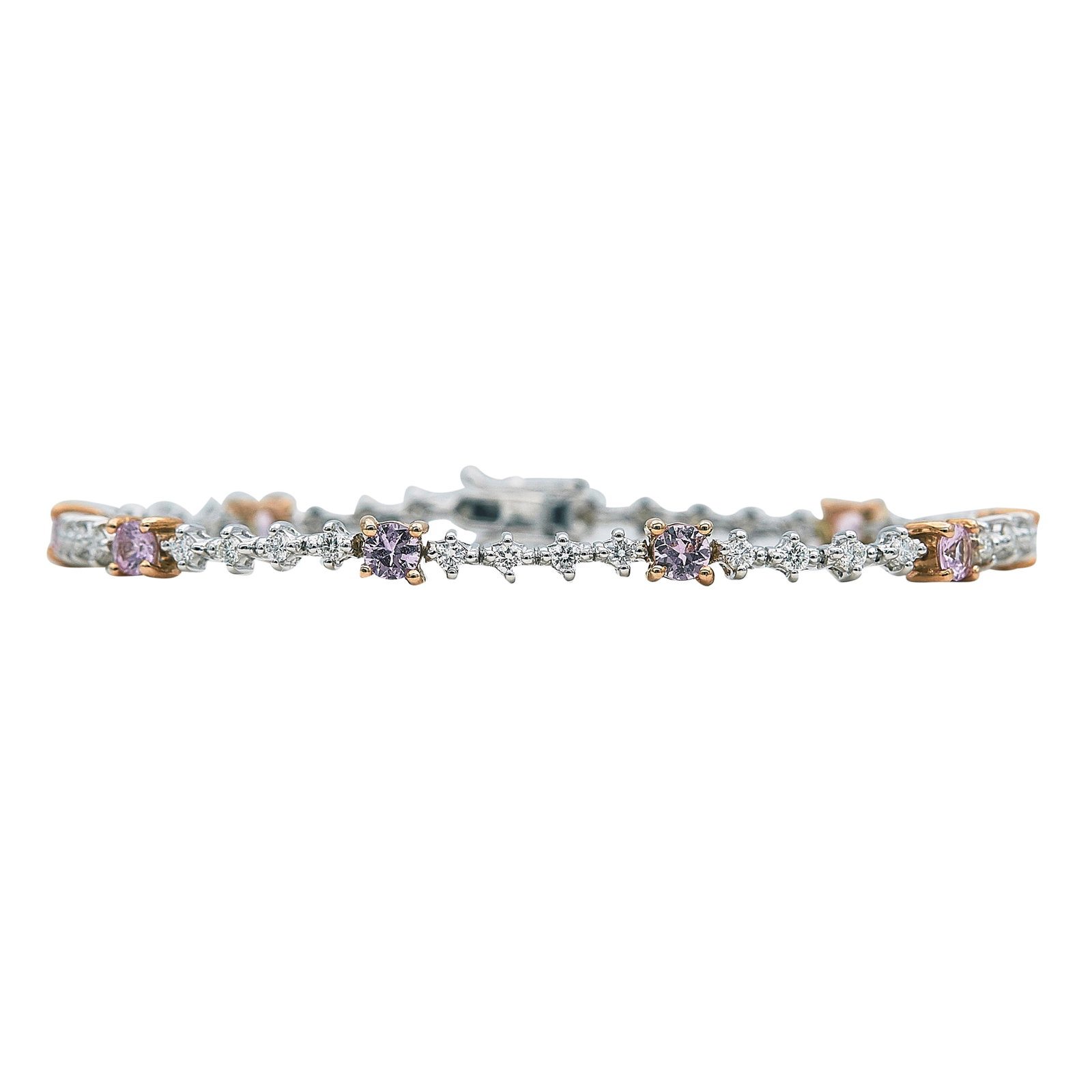 18K White and Rose Gold Pink Sapphire and Diamond Tennis Bracelet: METAL: 18K White Gold, 18K Rose Gold; APPROXIMATE TOTAL DIAMOND WEIGHT: 1.01 ctw; STAMPED: 18K, 750, 8S1.68, 38D 1.01D; CONDITION: Pre-owned, Very Good; ITEM WEIGHT (GRAMS): 9.8 g; MEASUREMENTS: Brace