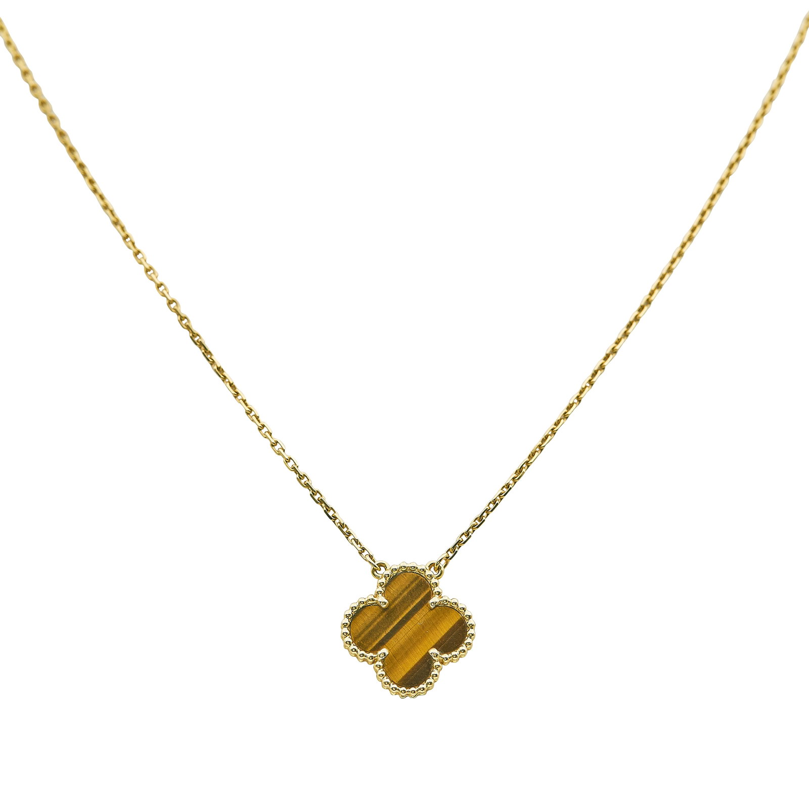 Van Cleef & Arpels Vintage Alhambra 18K Yellow Gold and Tiger's Eye Pendant Necklace: BRAND: VCA; COLLECTION: Alhambra (Vintage); METAL: 18K Yellow Gold; GEMSTONES: Tiger's Eye; STAMPED: Au750, VCA, serial number, French mark; CONDITION: Pre-owned, Very Good; ITEM WEIGHT (GRAMS): 5.25 