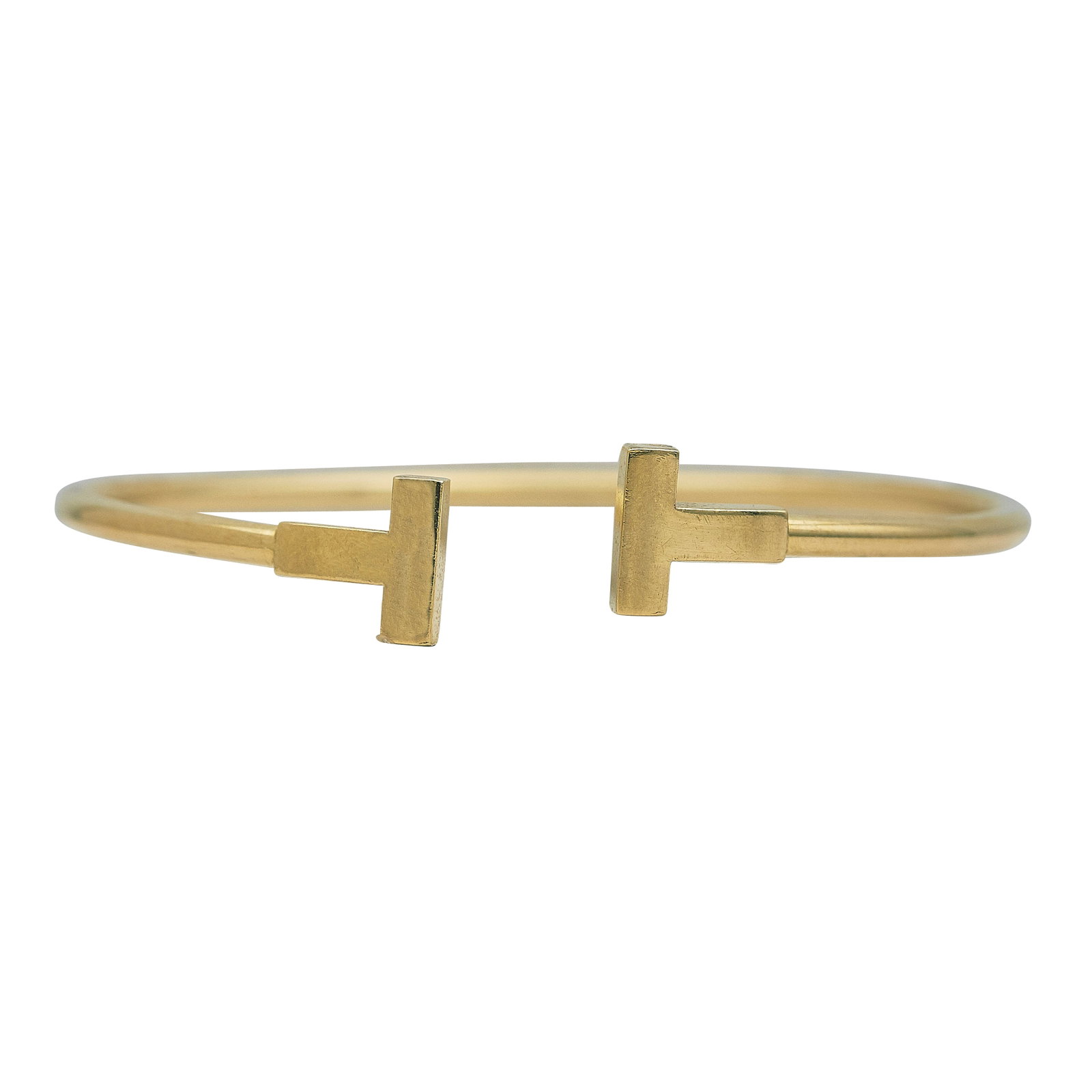 Tiffany & Co. Tiffany T 18K Yellow Gold Cuff Bracelet: BRAND: Tiffany & Co.; COLLECTION: Tiffany T; METAL: 18K Yellow Gold; STAMPED: © Tiffany & Co., Au750; CONDITION: Pre-owned, Good; ITEM WEIGHT (GRAMS): 8.6 g; MEASUREMENTS: Bracelet interior width 2 1