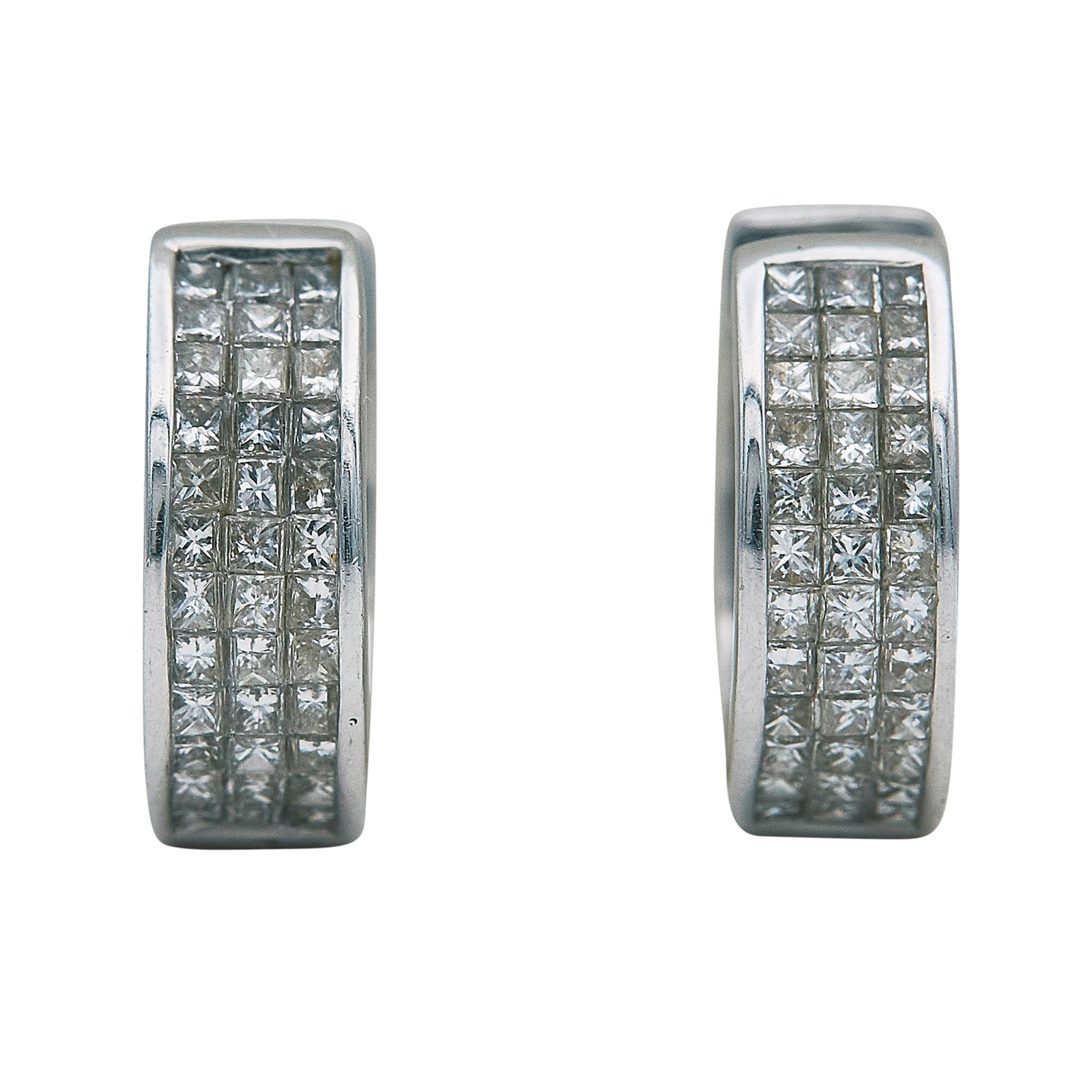 18K White Gold and Channel Set Diamond Huggie Earrings: METAL: 18K White Gold; APPROXIMATE TOTAL DIAMOND WEIGHT: 0.72 ctw; STAMPED: 750, 18K; CONDITION: Pre-owned, Very Good; ITEM WEIGHT (GRAMS): 5.5 g; MEASUREMENTS: Earrings 9/16 inch in diameter; ADDITIO