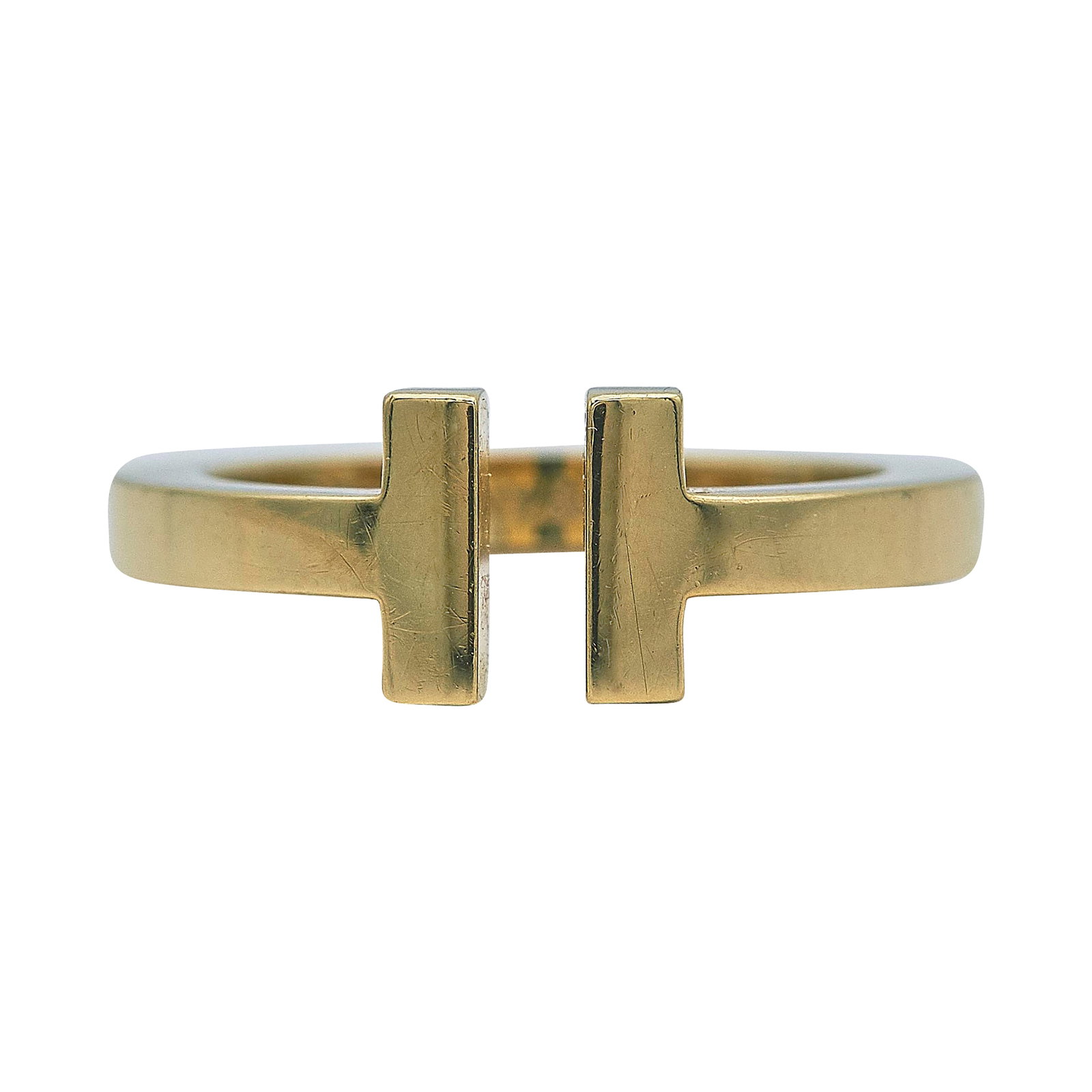 Tiffany & Co. Tiffany T 18K Yellow Gold Band Ring: BRAND: Tiffany & Co.; COLLECTION: Tiffany T; METAL: 18K Yellow Gold; STAMPED: © Tiffany & Co., Au750; CONDITION: Pre-owned, Very Good; ITEM WEIGHT (GRAMS): 6.8 g; MEASUREMENTS: Ring size 6 3/4
