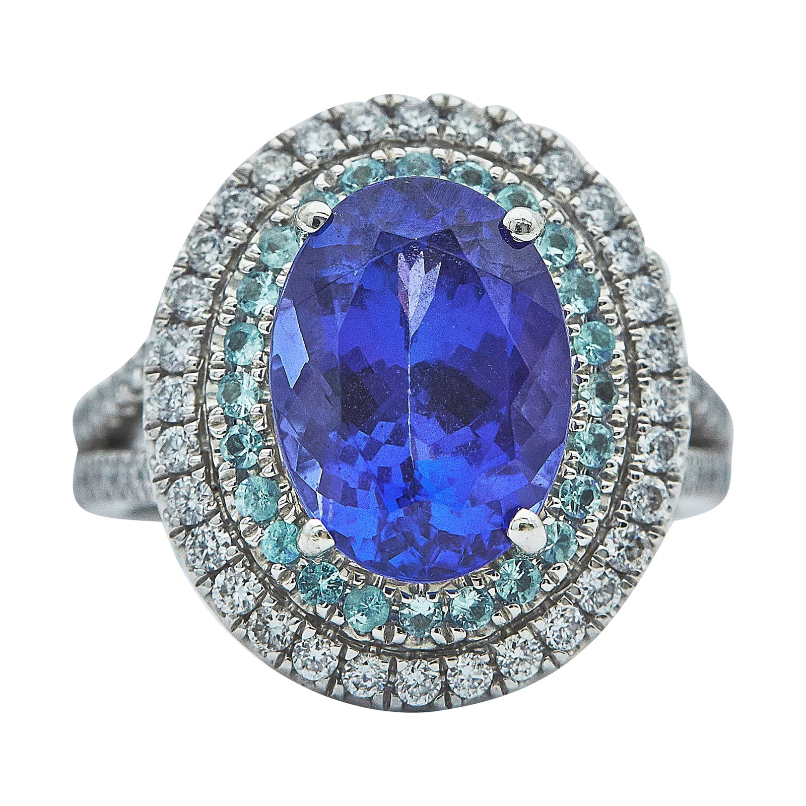 Rhapsody Platinum Tanzanite, Paraiba Tourmaline, and Diamond Halo Ring: METAL: Platinum; APPROXIMATE TOTAL DIAMOND WEIGHT: 0.70 ctw; APPROXIMATE DIAMOND COLOR(S): E-F; APPROXIMATE DIAMOND CLARITY: VS; GEMSTONES: Tanzanite approx. 4.59 carats, Paraiba Tourmaline approx. to