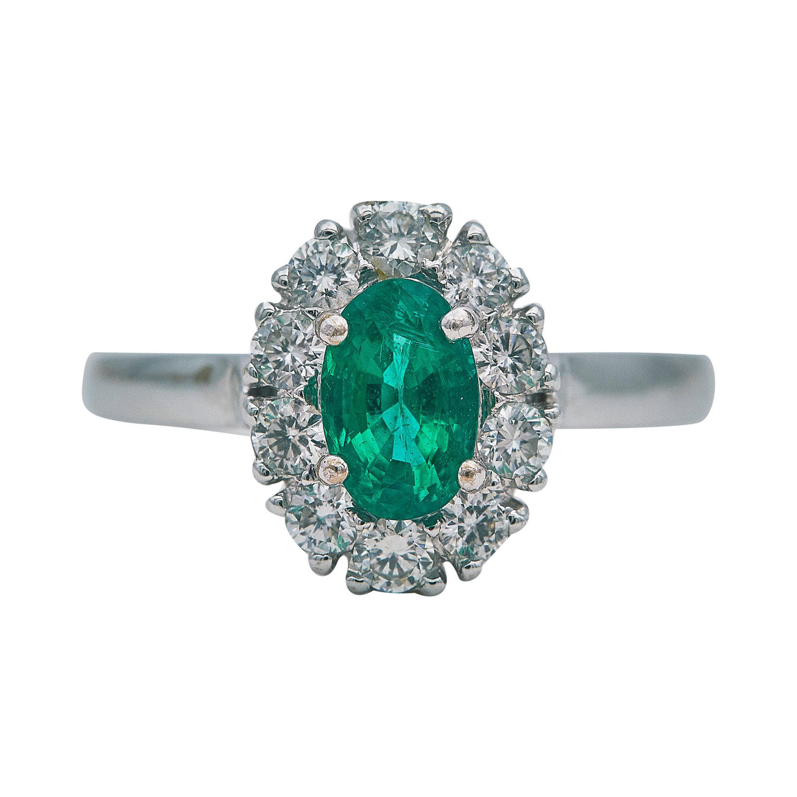 18K White Gold Emerald and Diamond Cluster Ring: METAL: 18K White Gold; APPROXIMATE TOTAL DIAMOND WEIGHT: 0.30 ctw; GEMSTONES: Emerald approx. 0.49 carats, Weight estimated by formula; TESTED: 18K White Gold; CONDITION: Pre-owned, Very Good; ITEM WE