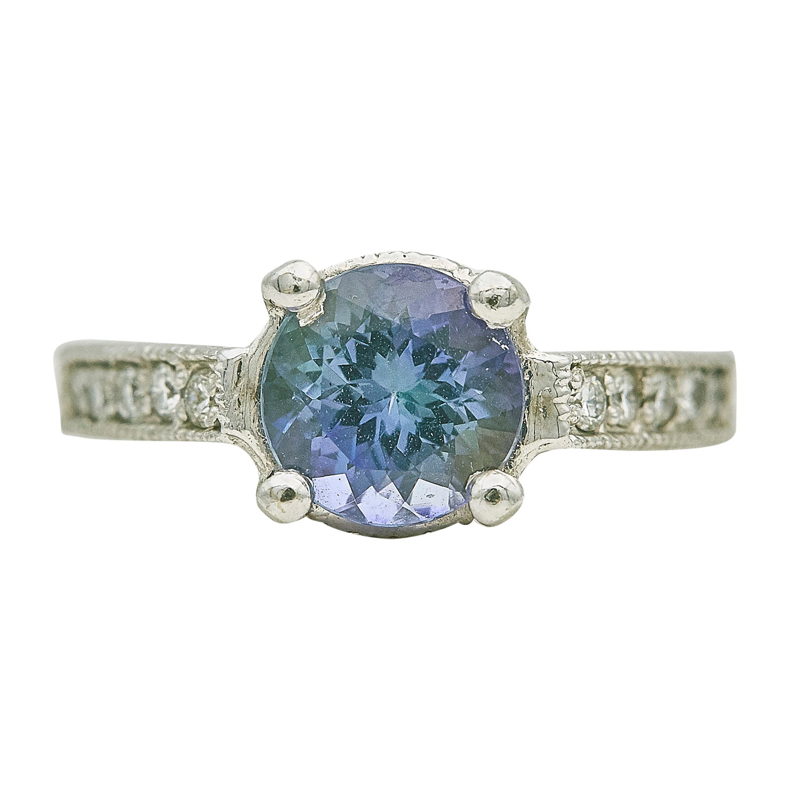 14K White Gold Tanzanite and Diamond Ring: METAL: 14K White Gold; APPROXIMATE TOTAL DIAMOND WEIGHT: 0.10 ctw; GEMSTONES: Tanzanite 7.7mm x 7.7mm x 5.2mm; STAMPED: 14K; CONDITION: Pre-owned, Good; ITEM WEIGHT (GRAMS): 4.9 g; MEASUREMENTS: Ring 