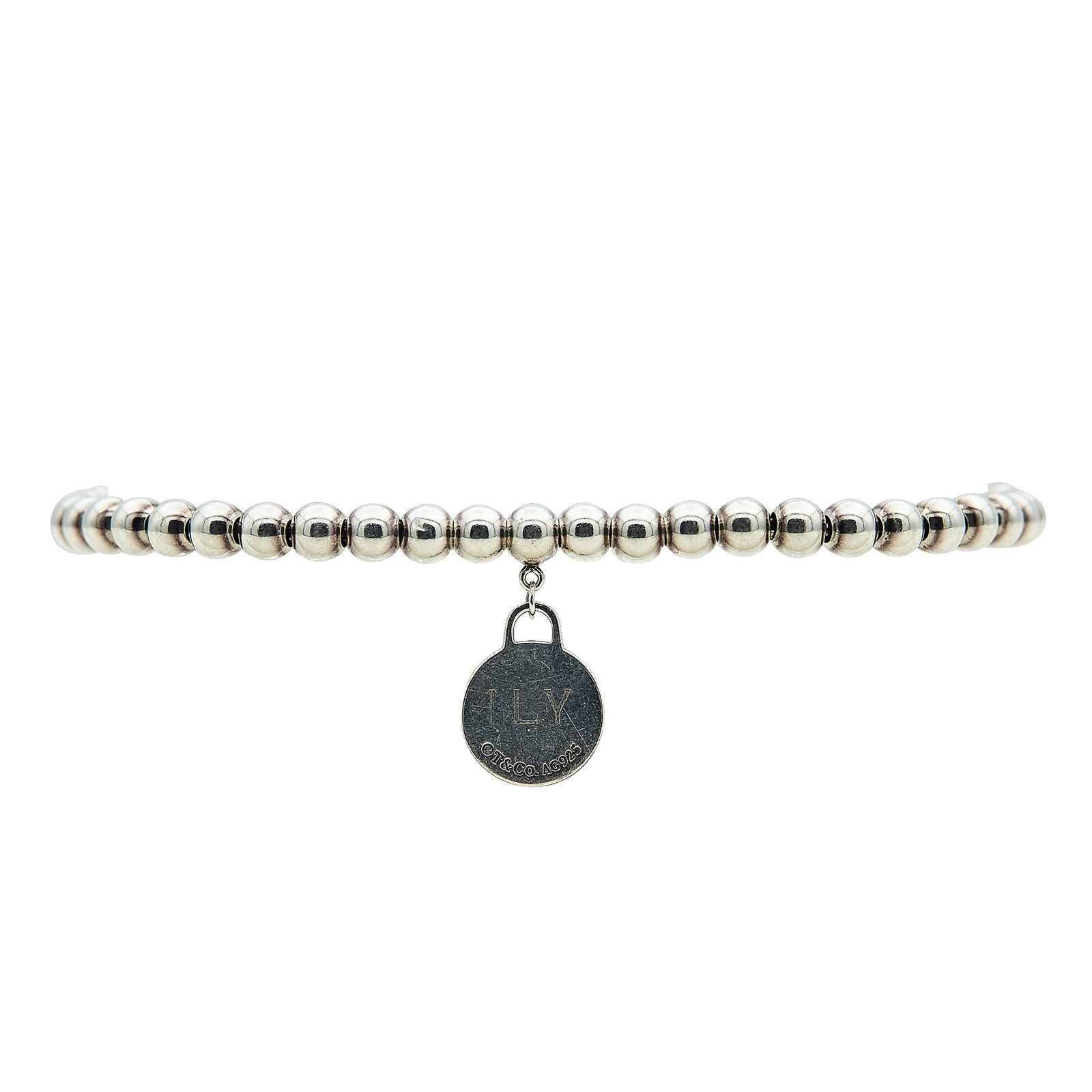 Tiffany & Co. Return To Tiffany Sterling Silver Beaded Charm Bracelet: BRAND: Tiffany & Co.; METAL: Sterling Silver; STAMPED: © T & Co., AG 925, Personal engraving; CONDITION: Pre-owned, Good; ITEM WEIGHT (GRAMS): 5.5 g; MEASUREMENTS: Bracelet 7 inches long
