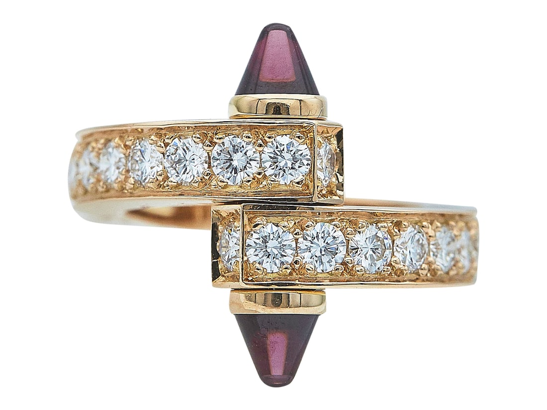 Cartier Menotte 18K Yellow Gold, Diamond, and Rhodolite Garnet Ring: BRAND: Cartier; COLLECTION: Menotte; METAL: 18K Yellow Gold; APPROXIMATE TOTAL DIAMOND WEIGHT: 1.50 ctw; GEMSTONES: Rhodolite Garnet; STAMPED: Cartier, 750, 51, © , Serial number, French marks; CONDI