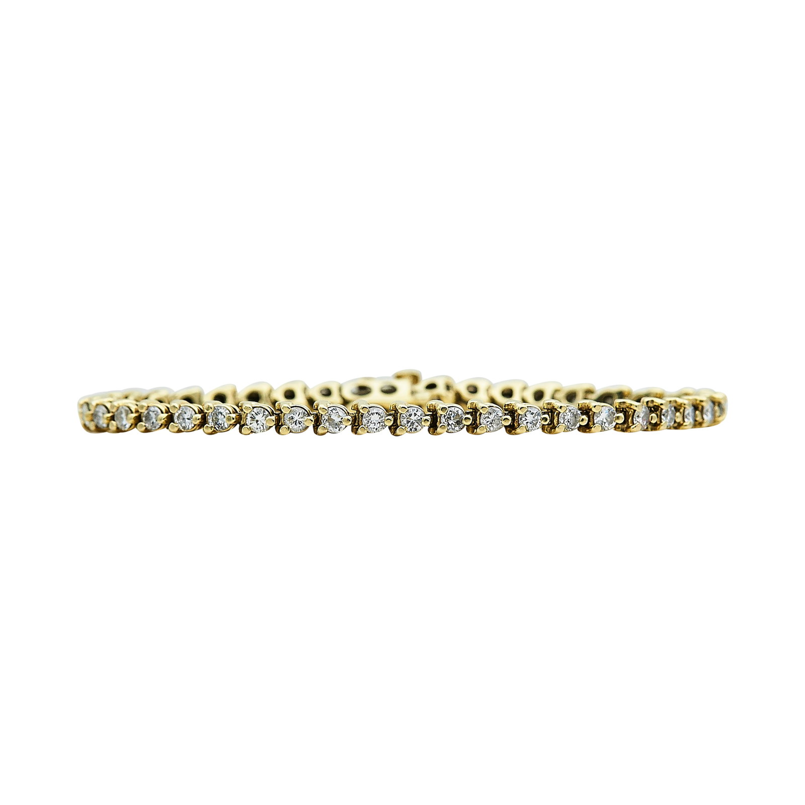 14K Yellow Gold and Diamond Three-Prong Tennis Bracelet: METAL: 14K Yellow Gold; APPROXIMATE TOTAL DIAMOND WEIGHT: 4.20 ctw; STAMPED: 14K, Maker's mark; CONDITION: Pre-owned, Good; ITEM WEIGHT (GRAMS): 11.8 g; MEASUREMENTS: Bracelet approx. 7 inches long x 