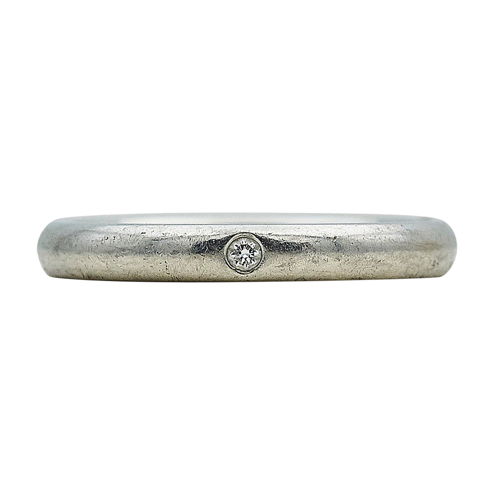 Elsa Peretti for Tiffany & Co. Platinum and Single Diamond Band Ring: BRAND: Elsa Peretti for Tiffany & Co.; METAL: Platinum; APPROXIMATE TOTAL DIAMOND WEIGHT: 0.02 ctw; STAMPED: Peretti, Pt950, Tiffany & Co.; CONDITION: Pre-owned, Good; ITEM WEIGHT (GRAMS): 5.7 g; MEAS