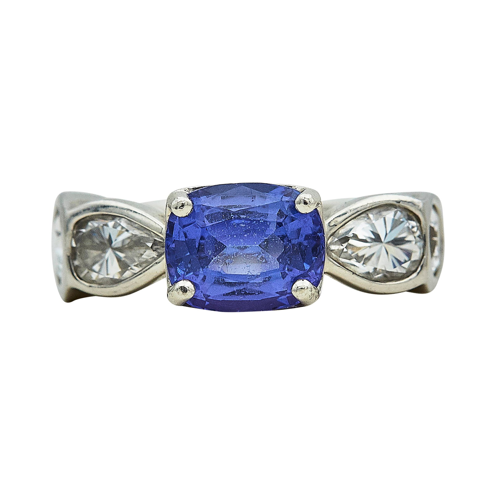 Platinum, Tanzanite, and Pear Cut Diamond Ring: METAL: Platinum; APPROXIMATE TOTAL DIAMOND WEIGHT: 1.56 ctw; GEMSTONES: Tanzanite approx. 7.00 mm x 8.50 mm; TESTED: Platinum; CONDITION: Pre-owned, Good; ITEM WEIGHT (GRAMS): 14.65 g; MEASUREMENTS: R