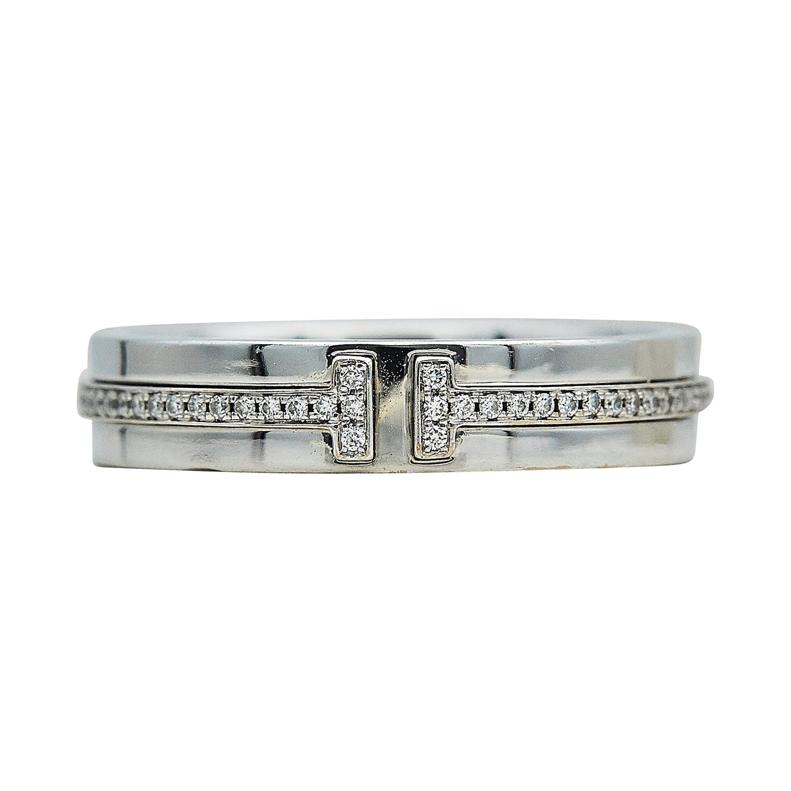 Tiffany & Co. Tiffany T 18K White Gold and Diamond Band Ring: BRAND: Tiffany & Co.; COLLECTION: Tiffany T; METAL: 18K White Gold; APPROXIMATE TOTAL DIAMOND WEIGHT: 0.18 ctw; STAMPED: © Tiffany & Co., Au750; CONDITION: Pre-owned, Very Good; ITEM WEIGHT (GRAMS): 