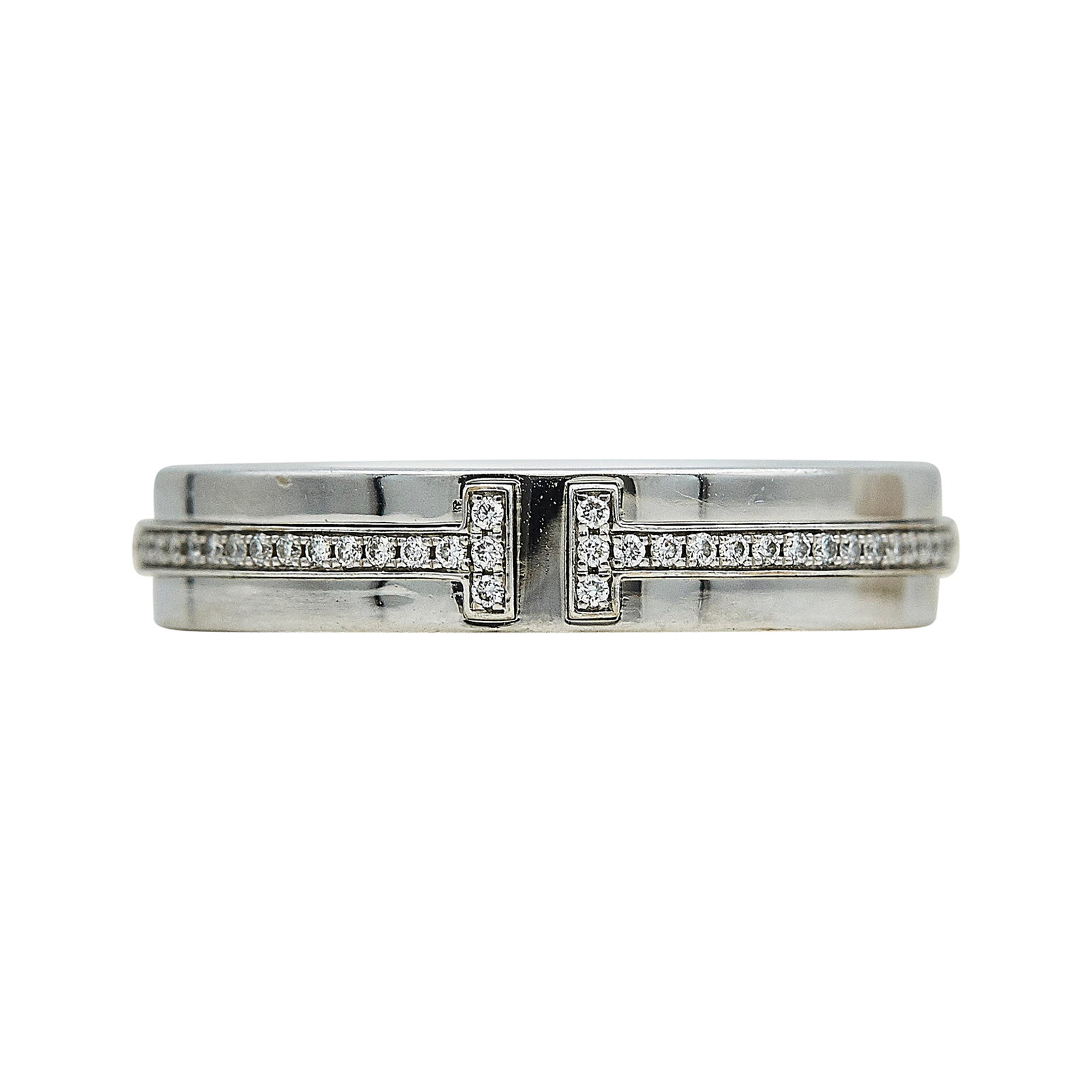 Tiffany & Co. Tiffany T 18K White Gold and Diamond Band Ring: BRAND: Tiffany & Co.; COLLECTION: Tiffany T; METAL: 18K White Gold; APPROXIMATE TOTAL DIAMOND WEIGHT: 0.18 ctw; STAMPED: © Tiffany & Co., Au750; CONDITION: Pre-owned, Very Good; ITEM WEIGHT (GRAMS): 