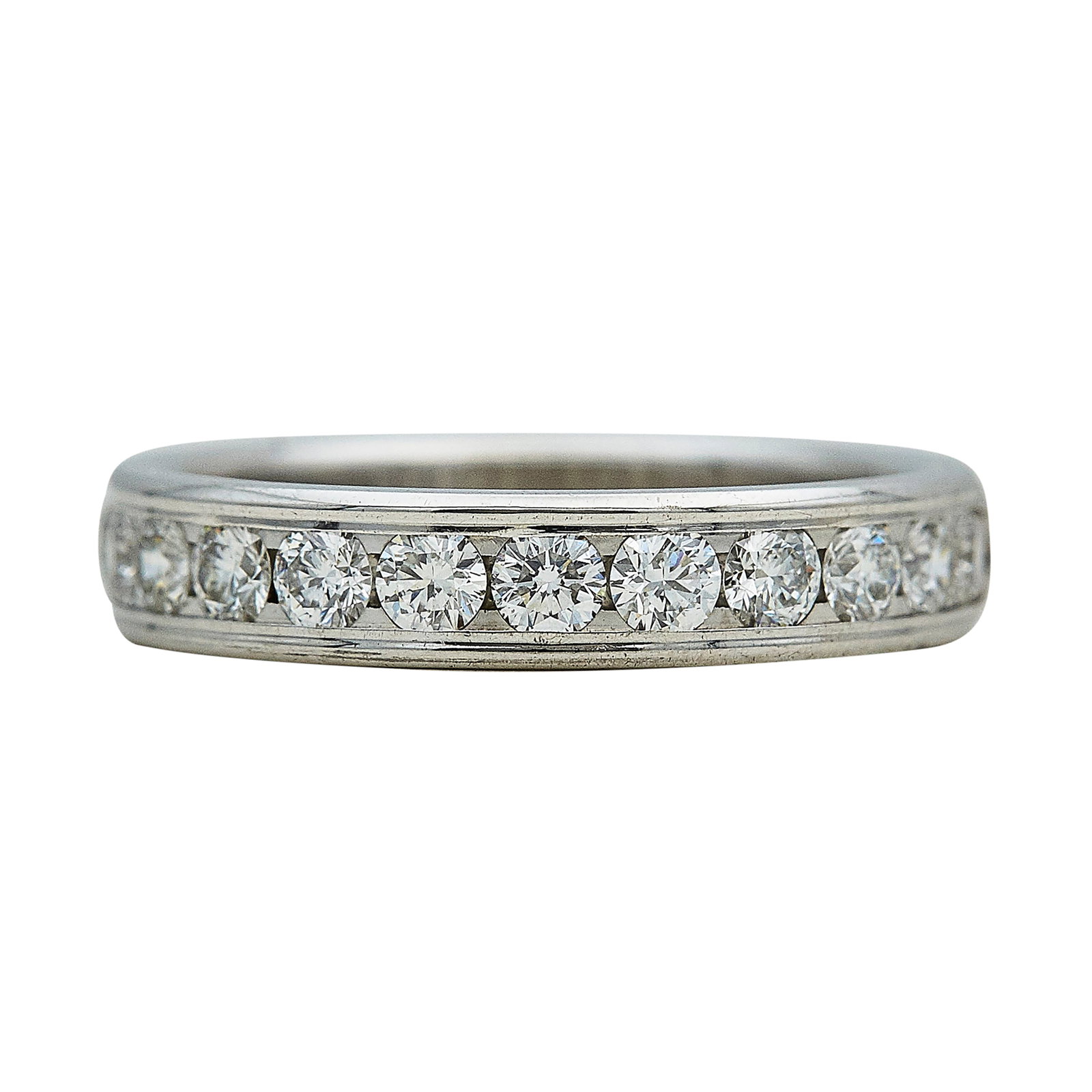 14K White Gold and Channel Set Diamond Half-Eternity Band Ring: METAL: 14K White Gold; APPROXIMATE TOTAL DIAMOND WEIGHT: 0.72 ctw; STAMPED: Undefined mark, 14K; CONDITION: Pre-owned, Very Good; ITEM WEIGHT (GRAMS): 3.7 g; MEASUREMENTS: Ring size 6