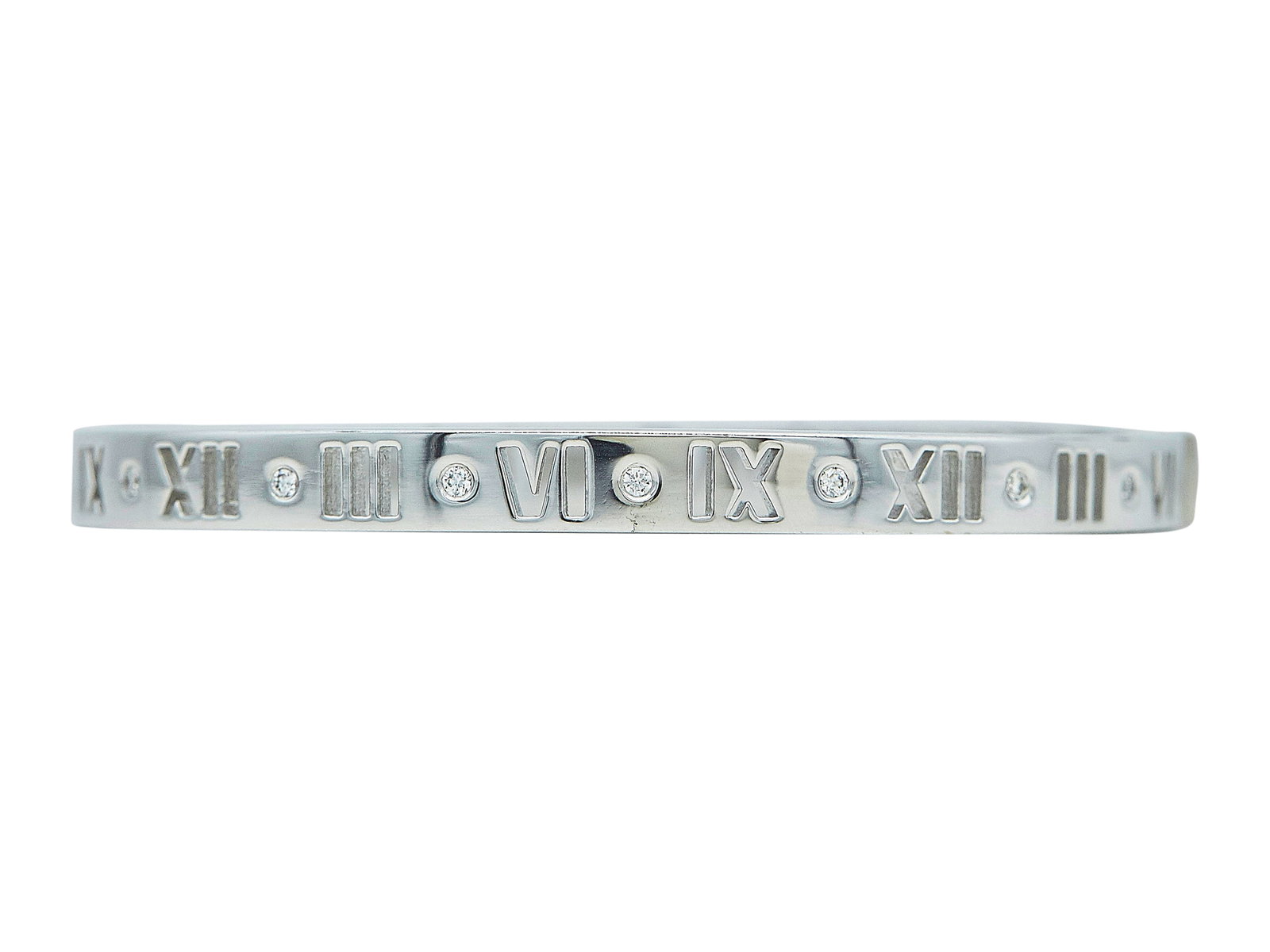 Tiffany & Co. Atlas 18K White Gold and 7 Diamond Bracelet: BRAND: Tiffany & Co.; COLLECTION: Atlas; METAL: 18K White Gold; APPROXIMATE TOTAL DIAMOND WEIGHT: 0.15 ctw; STAMPED: © T & Co., AU750; CONDITION: Pre-owned, Very Good; ITEM WEIGHT (GRAMS): 29.7 g; ME