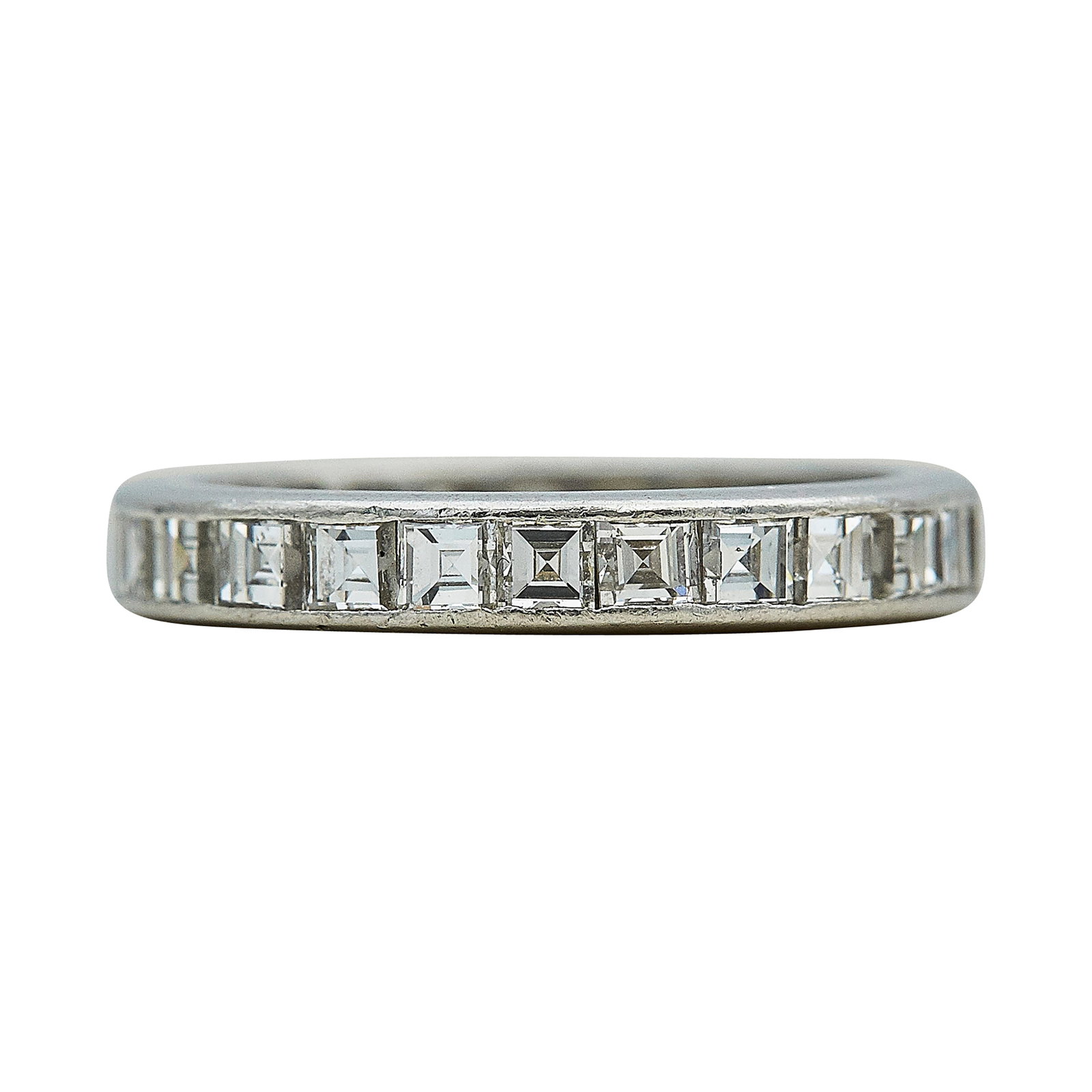 Platinum and Carre Diamond Chanel-Set Eternity Band Ring: METAL: Platinum; APPROXIMATE TOTAL DIAMOND WEIGHT: 1.96 ctw; TESTED: Platinum; CONDITION: Pre-owned, Good; ITEM WEIGHT (GRAMS): 3 g; MEASUREMENTS: Ring size 5