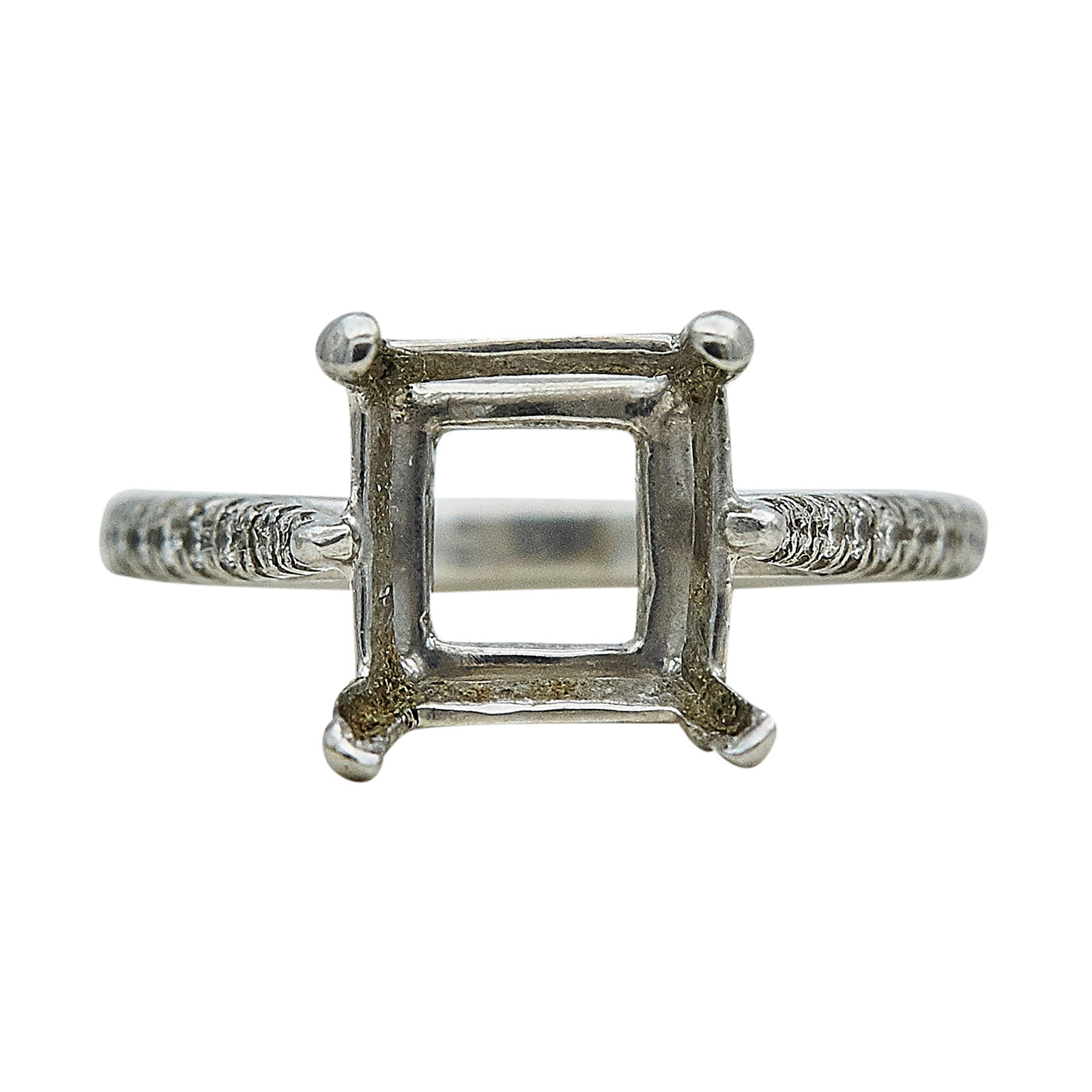 Platinum and Diamond Engagement Ring Setting: METAL: Platinum; APPROXIMATE TOTAL DIAMOND WEIGHT: 0.11 ctw; TESTED: Platinum; CONDITION: Pre-owned, Good; ITEM WEIGHT (GRAMS): 3.3 g; MEASUREMENTS: Ring size 4, Center will fit approx. 7.10 mm square