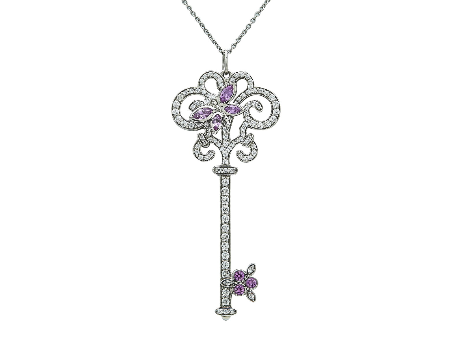 Tiffany & Co. Platinum, Diamond, and Pink Sapphire Butterfly Key Pendant Necklace: BRAND: Tiffany & Co.; COLLECTION: Tiffany Keys; METAL: Platinum; APPROXIMATE TOTAL DIAMOND WEIGHT: 0.90 ctw; GEMSTONES: Pink Sapphire; STAMPED: © Tiffany & Co., Pt950; CONDITION: Pre-owned; ITEM WEIG