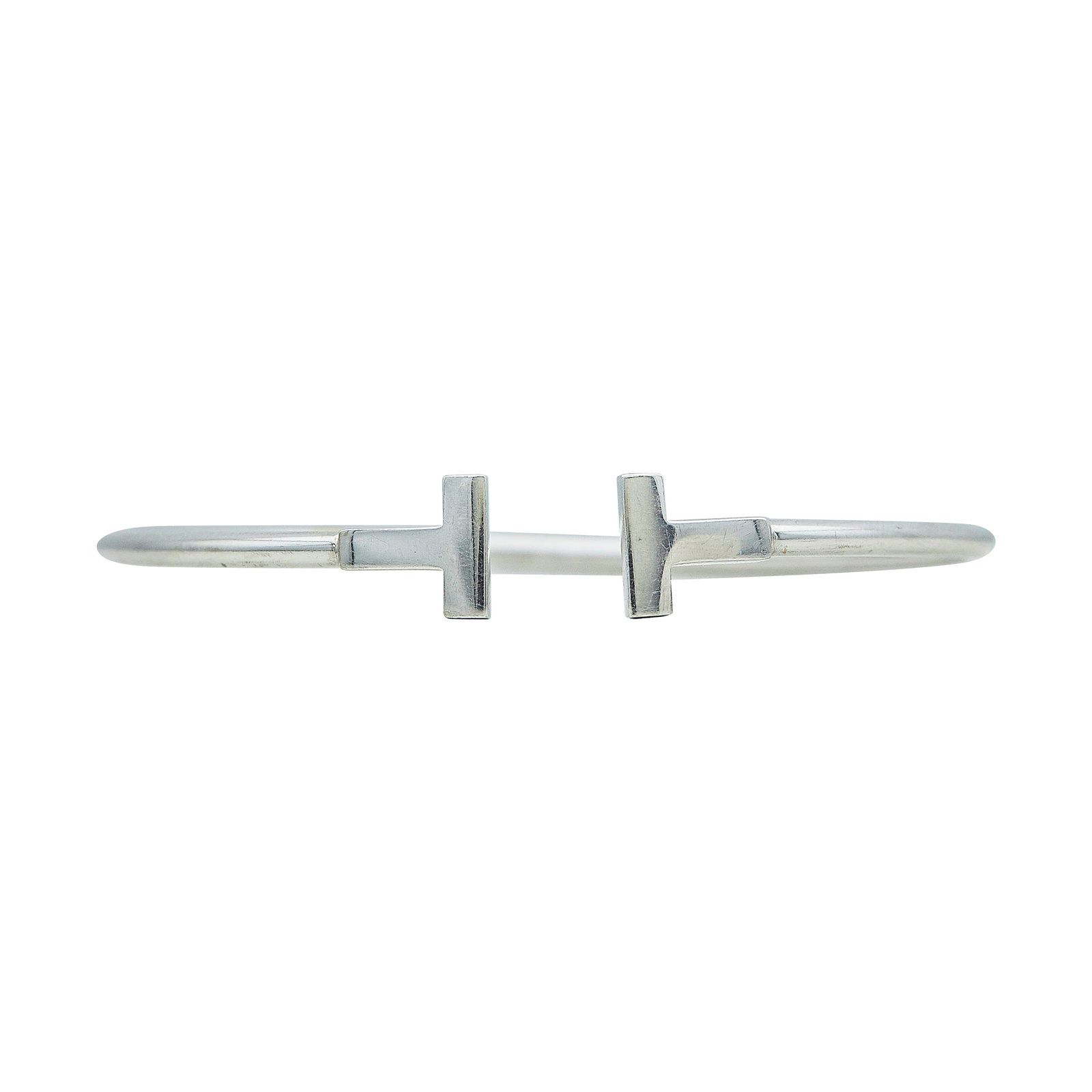 Tiffany & Co. Tiffany T 18K White Gold Bracelet: BRAND: Tiffany & Co.; COLLECTION: Tiffany T; METAL: 18K White Gold; STAMPED: © T & Co., Au750, Italy; CONDITION: Pre-owned, Good; ITEM WEIGHT (GRAMS): 9 g; MEASUREMENTS: Bracelet inner circumference 