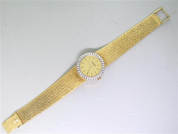 Corum 18k Gold Diamond Watch w. Bracelet: 24mm in diameter 18k gold Corum watch with approx. 0.80 - 0.90ctw diamond bezel with attached 18k gold Corum Bracelet , Manual wind 17jewels 3position adj. Corum movement. Total Length -7". Weigh