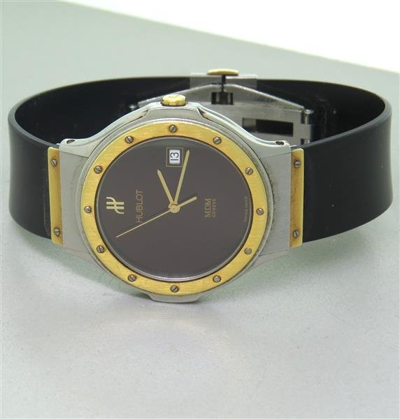 Hublot 18k Gold Steel Rubber Band Watch: 18k gold and stainless steel case - 35mm in diameter,excl. crown and lug tip.s Rubber strap and hidden deployant buckle signed Hublot. Date at 3 o'clock.
