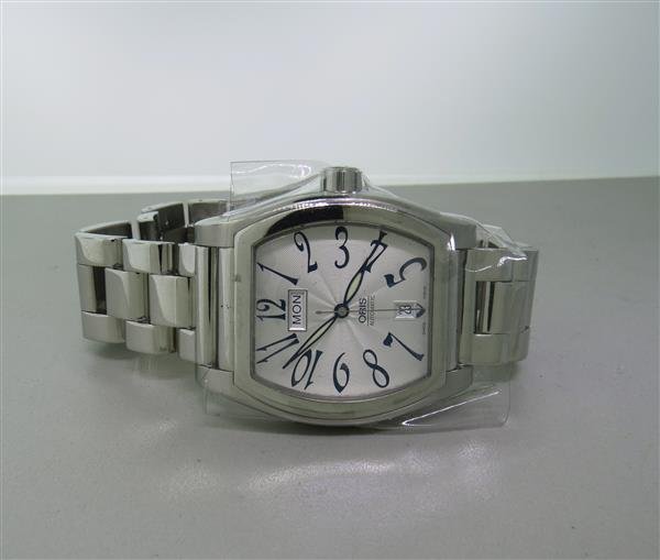 Oris Skeleton Back Automatic Watch NOS: Case - tonneau shape, 37mm exlc. crown x 38mm excl .lug tips. Automatic movement,running order. skeleton back. Day at 12 o'clock, date at 6 o'clock, center second hand.New old stock.