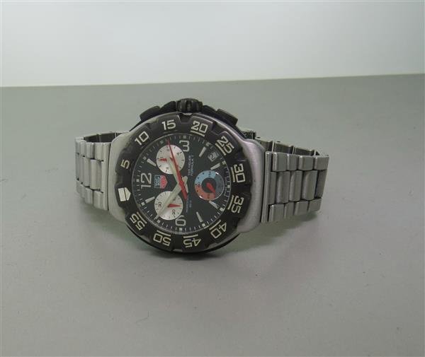 Tag Heuer Formula 1 Chronograph Mens Watch DN3714: 41mm Case. Unidirectional Rotating Bezel. Functions: Hours, Minutes, Seconds, Date, Chronograph. Bracelet Fits 7" Wrist. Watch Is Running but Crown Is Loose. Chronograph has to be reset.