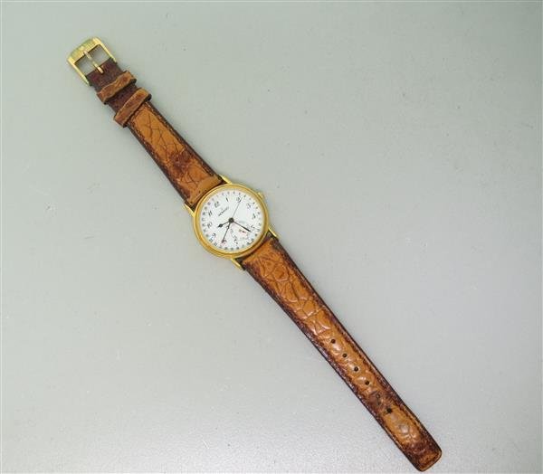 Movado Gold Tone Ladies Watch: 28mm Stainless Steel Gold Tone Case. Functions: Hours, Minutes, Seconds, Day, Date. Quartz Movement. Working Order.