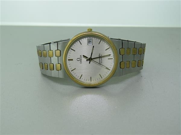 Omega Seamaster Quartz Two Tone Watch: Two tone case - 32mm in diameter. Quartz movement - not running . Silver dial with applied gold markers, date at 3 o'clock. original band and buckle.