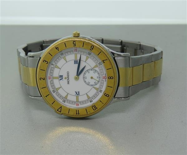 Movado Two Tone Stainless Steel Watch: Two tone steel case - 34mm in diameter. Quartz movement - running order. White dial, rotating bezel,small second hand at 6 o'clock.