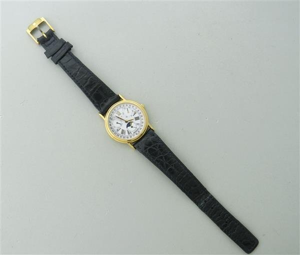 Movado Gold Tone Day Date Moonphase Watch: Gold tone case - 27mm in diameter. Quartz movement - running order. White dial with roman numerals,3 sub dials with moonphase,day and date. Water resistant case.