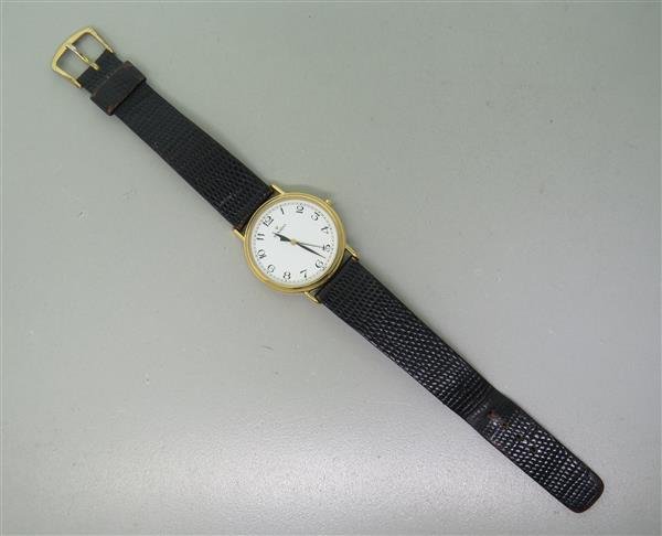 Movado Gold Tone Leather Band Watch: Case - 33mm in diameter. Quartz movement - running order.. White dial with arabic numerals,center second hand.