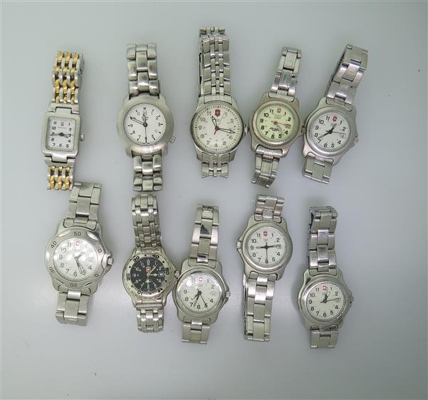 Lot of 10 Swiss Army Stainless Steel Watches: 10 Swill Army steel watches. Functions - hour,minute,second hand,date at 3 and 4 o'clock. Quartz movement - all not running. Some crystals are scratched.
