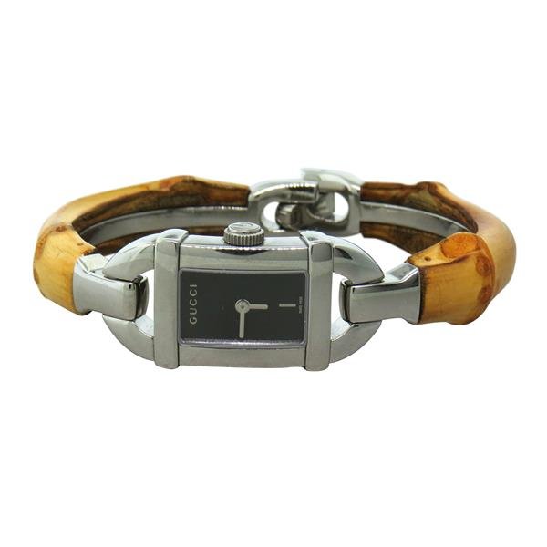 Gucci Petite Bamboo Ladies Watch 6800L: Stainless steel case - 16mm x 43mm lug tip to lug tip. Quartz movement - running. Bamboo bracelet 6 1/4" long, with Gucci buckle.