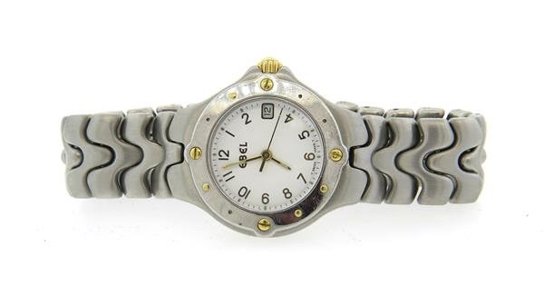Ebel Sportwave Steel 18k Gold Watch: Case - 27mm in diameter. White dial with gold arabic numeral markers, center second hand, date at 3 o'clock. Ebel band and buckle, quartz movement - running orderWatches are guaranteed to be in ru