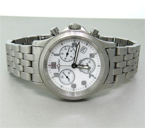 Hamilton Chronograph Stainless Steel Watch: Case - 38mm in diameter. Quartz movement - running order. White dial with 3 reg. chronograph, date at 4 o'clock. Original band and buckle.Watches are guaranteed to be in running order, if describe