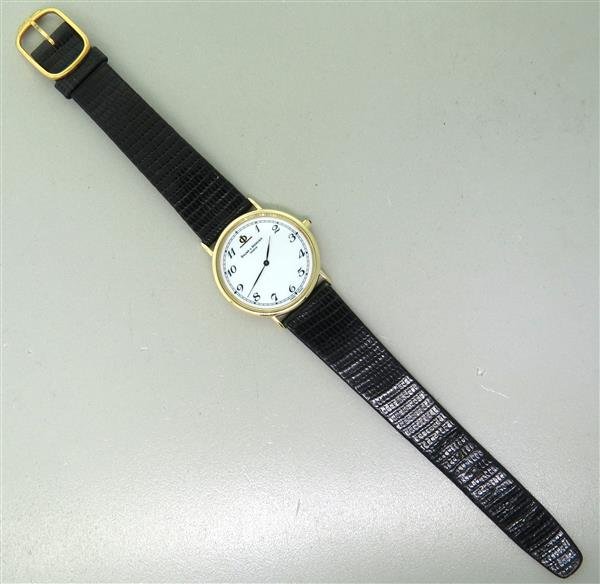 Baume & Mercier 14k Gold Watch: 14k gold case - 31mm in diameter. Quartz movement - not running. White dial with arabic black numerals, original leather band, buckle.Watches are guaranteed to be in running order, if described as suc