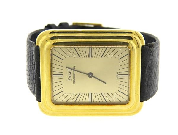 Piaget 18k Gold Backwind Watch: 18k gold case - 28mm x 34mm lug tip to lug tip. Backwind, quartz movement - not running. Gold dial with black markers. Case back marked 74121, 338807.Watches are guaranteed to be in running order, if