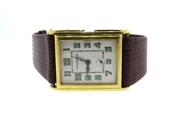 1920s Longines 18k Gold Watch: 18k gold case - 26mm x 35mm lug tip to lug tip. White dial with green arabic numerals, small second hand. Triple signed. Manual wind -= running order. Very minor loss of paint on number 6.Color stones