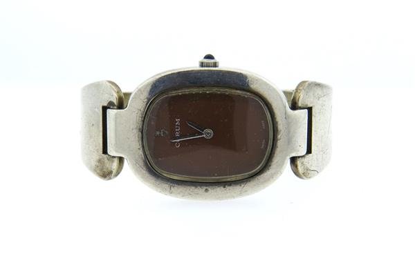 1970s Corum Sterling Manual Wind Watch: Sterling case - 27mm excl crown x 41mm. Band will fit up to 6 1/4" wrist . Manual wind movement - running order. Sapphire crown, minor loss of paint on dial.Color stones have not been tested for